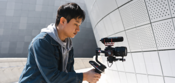 Student Filmmaker holding a camera