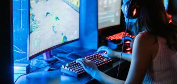 Young woman playing video games on computer