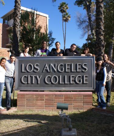 Students Standing Next to the LACC Sign 