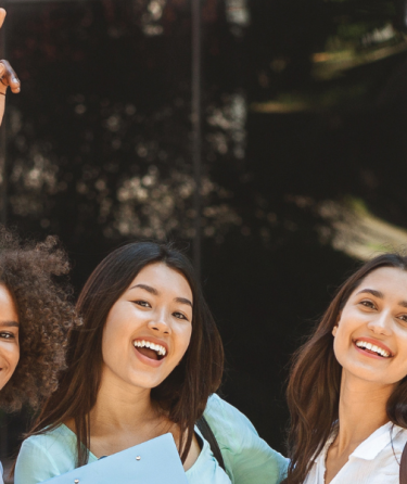Five friends smiling at the camera