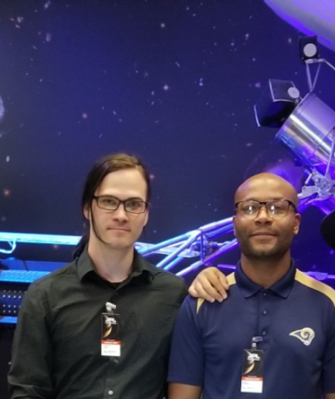 LACC students standing next to a poster presentation