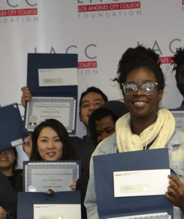 students with scholarship certificates