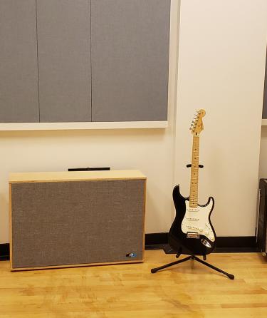 An electric guitar and amplifier in the HAMC recording studio.