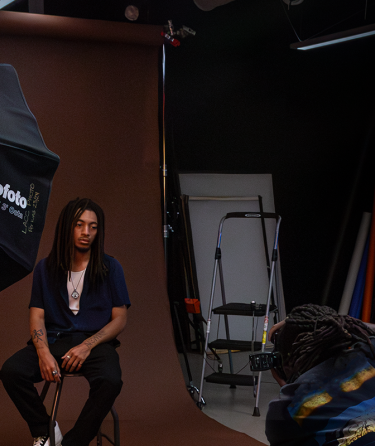 Student photographing in the LACC Studio