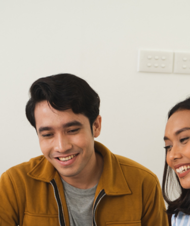 Four students looking at a laptop