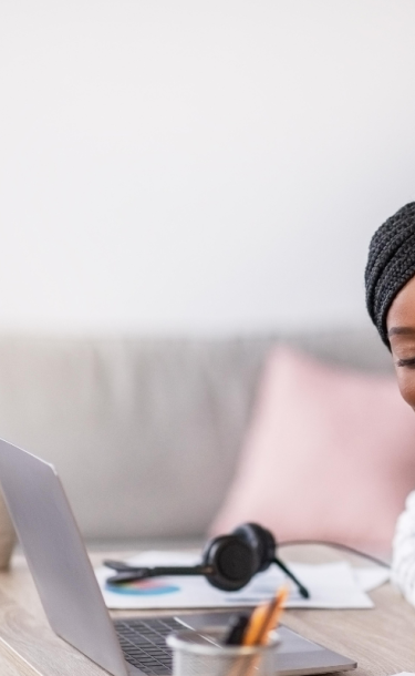 Student studying on laptop at her living room