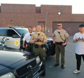 Sheriff's personnel and community member utilizing drones