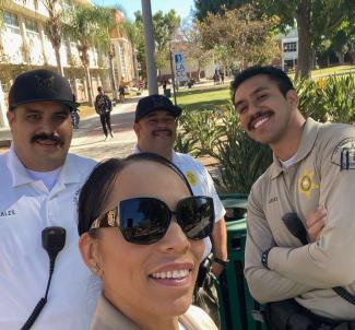 Sheriff's personnel taking a group photo after a briefing outside the Theater Building.