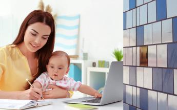 Woman Studying Holding her Baby