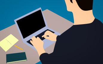 Man typing on notebook computer