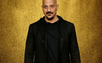 Portrait of Film Director Alumni, Albert Hughes against a sparkle-ey gold backdrop