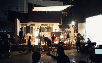 silhouetted people on a well list sound stage filming a cinematic scene