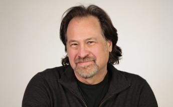 a portrait of Editor Dan Bootzin against a white wall