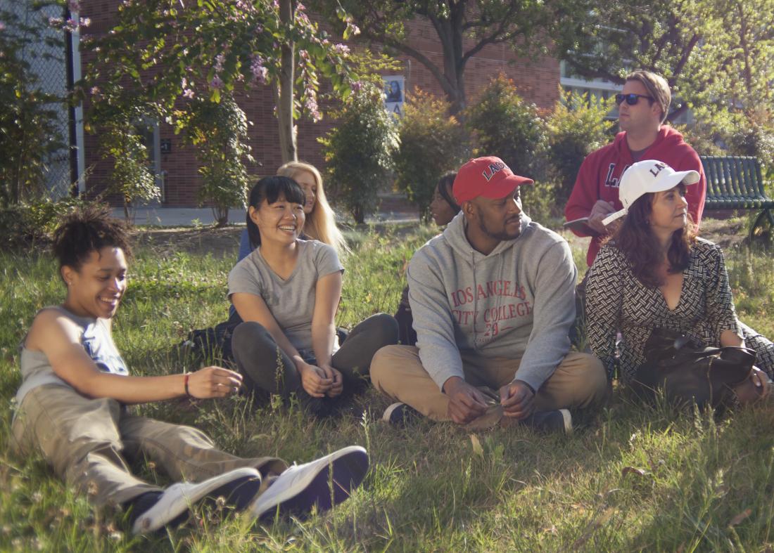 Students Having Fun on the Grass 