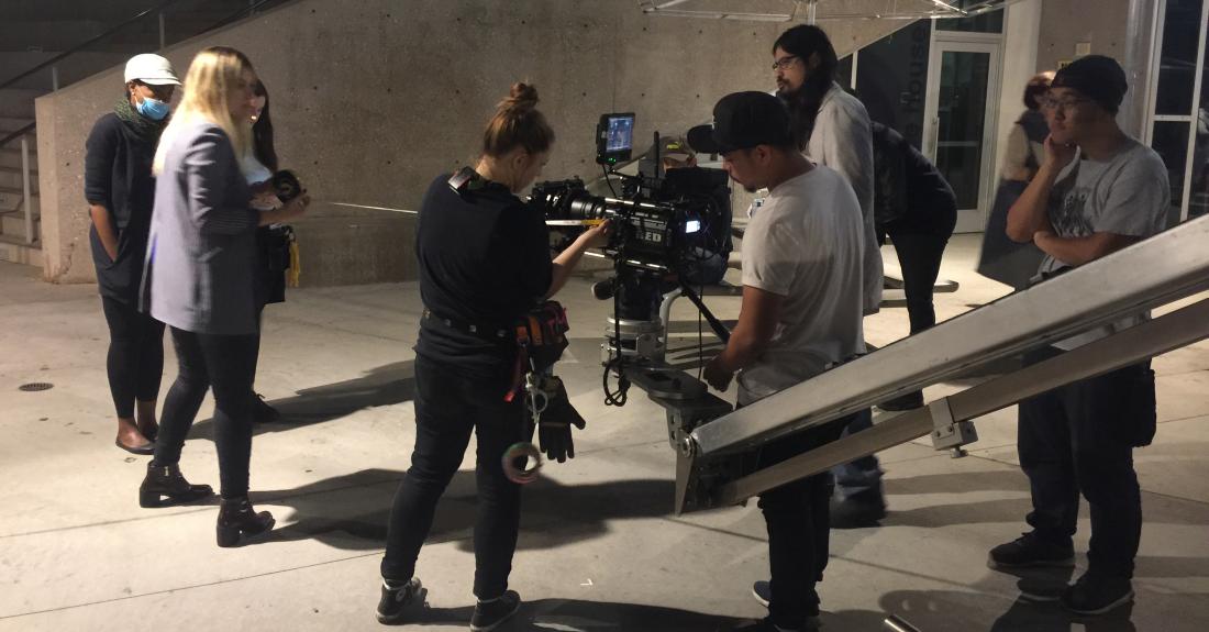 Students setup a camera for a shot.