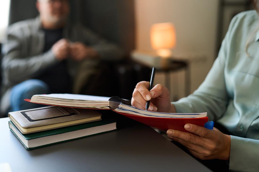 person writing in notebook