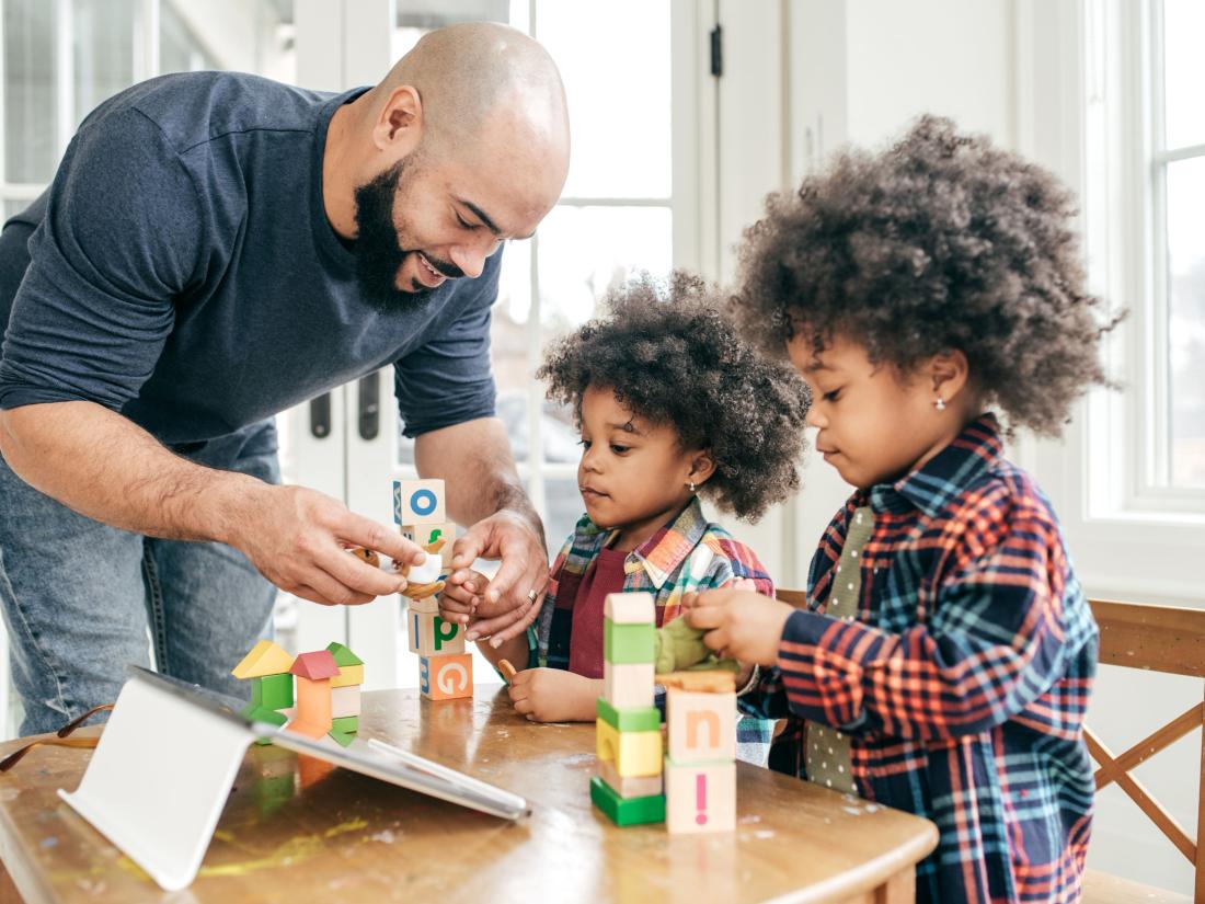 Parent playing table games with his kids.