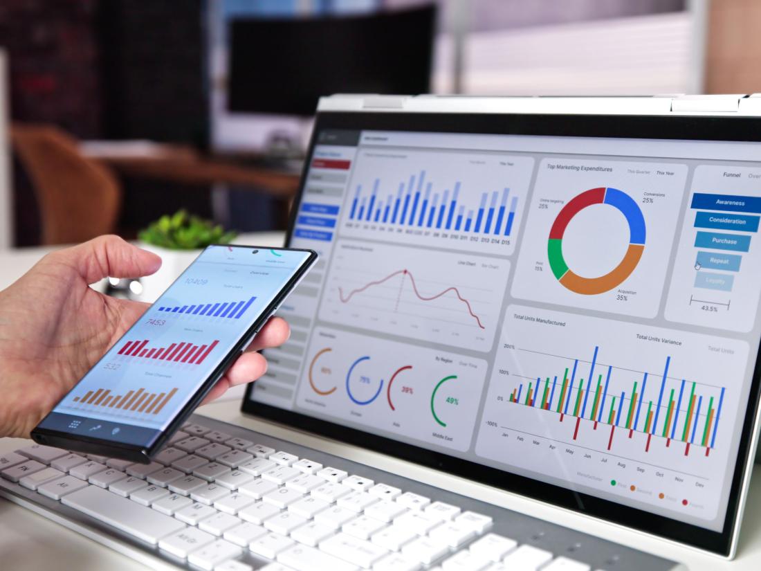 Reviewing charts on cellphone and laptop