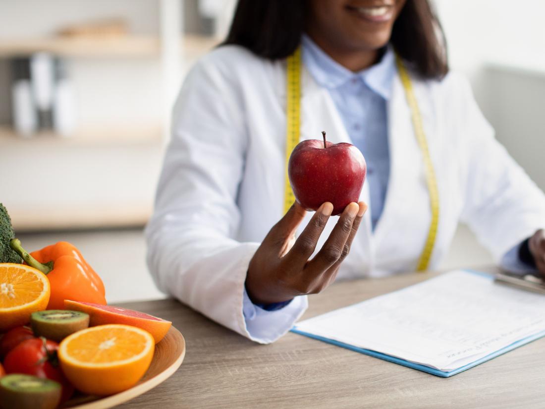 Doctor holding an apple.