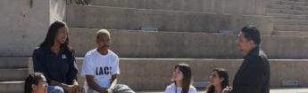 chancellor and students on stairs