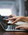 Hand pointing laptop screen
