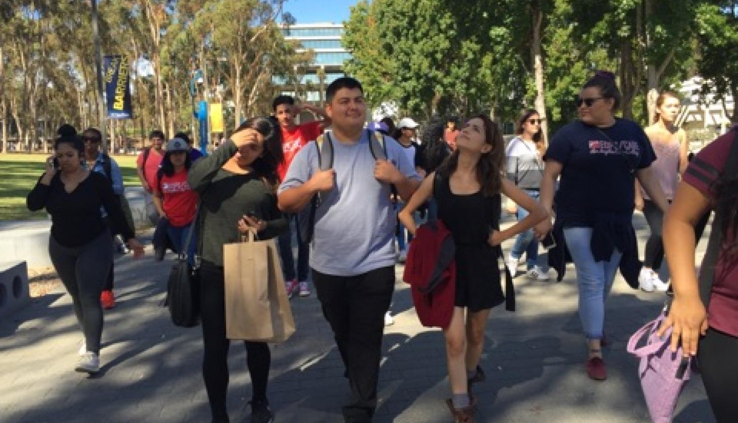 Smiling Students Walking in the University's Nature Zone