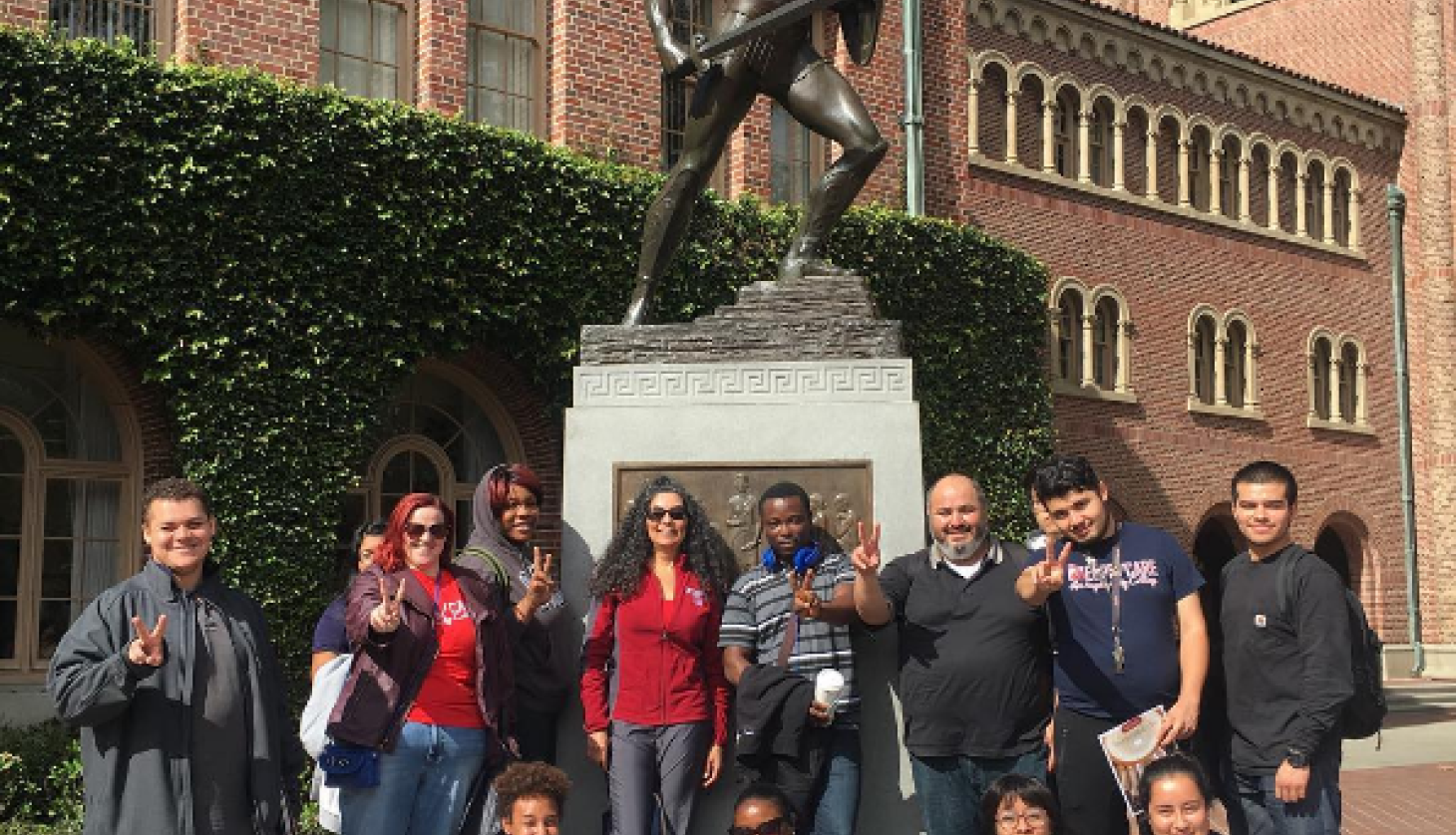 Young Students Under University Warrior Statue