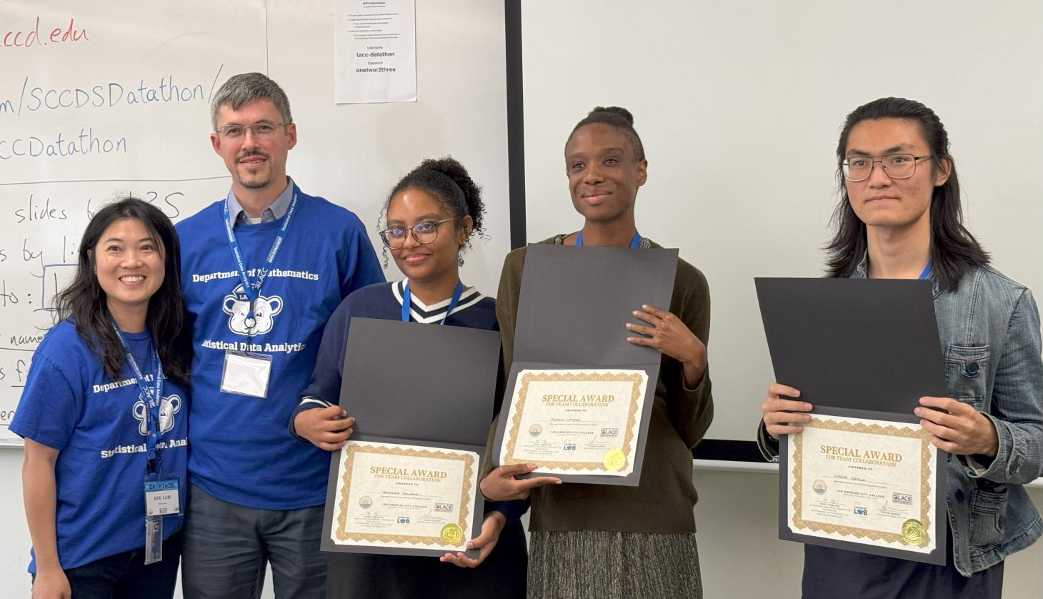 two faculty stands with three students and their certificates