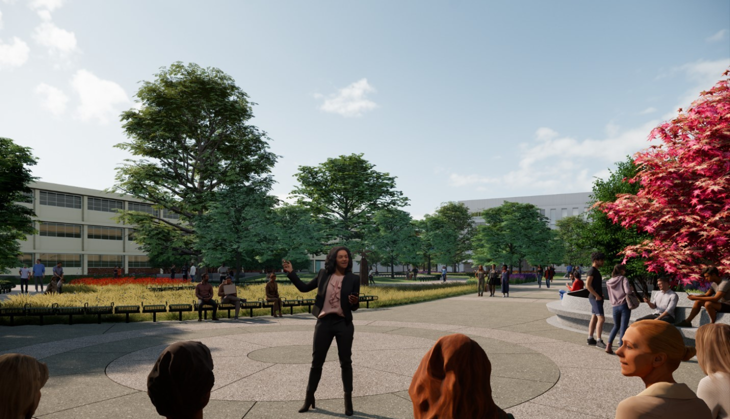 A woman speaks in front of a group on the Main Quad